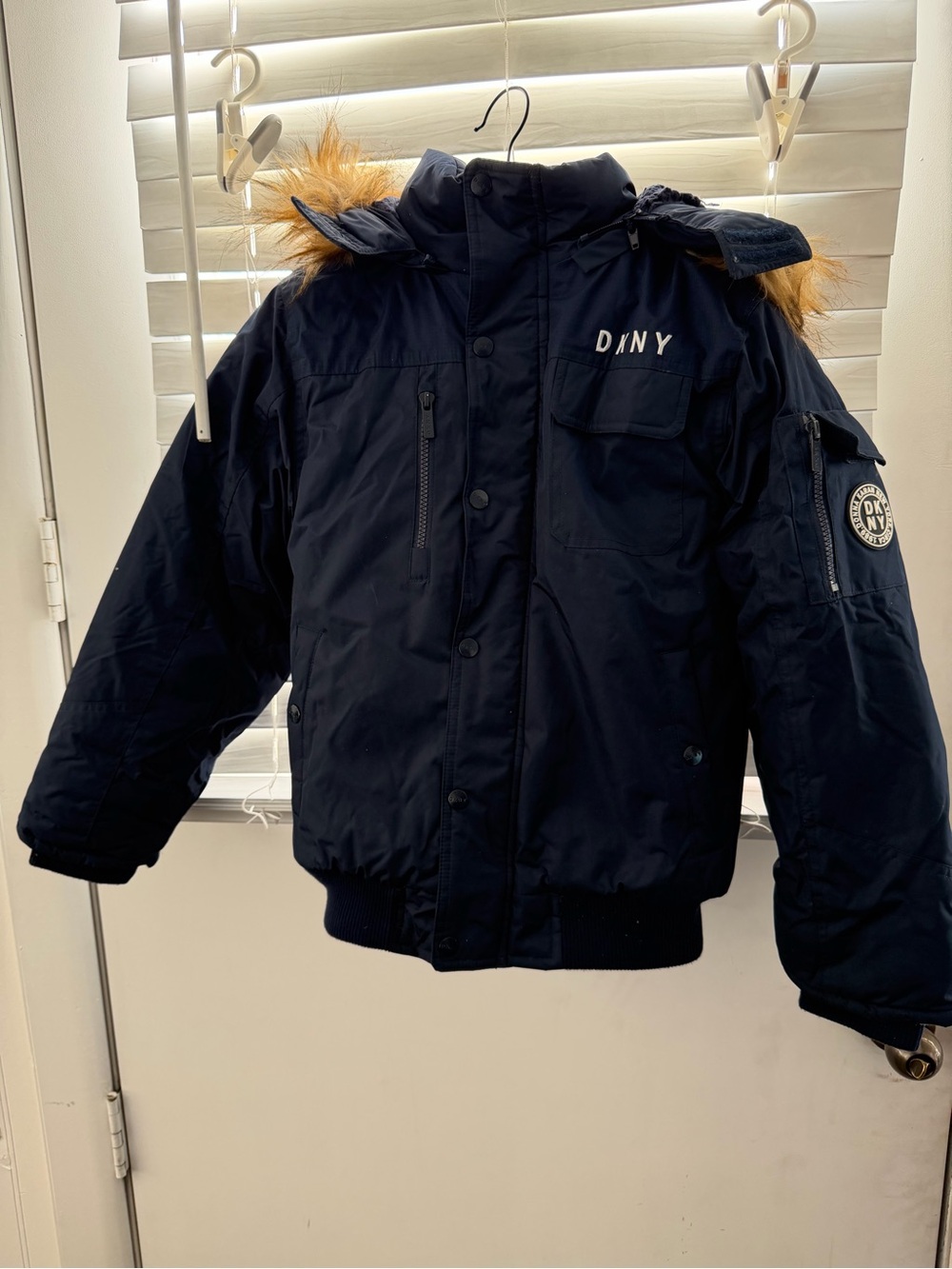 DKNY kids’ winter jacket in classic dark navy with a removable faux-fur trimmed